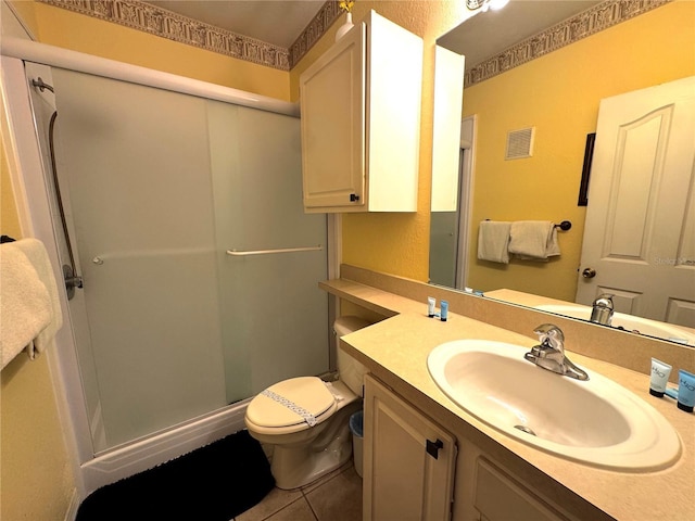 8809 Dunes Ct Unit 201, Kissimmee, FL 34747 - bathroom with a shower stall, vanity, toilet, and tile patterned floors