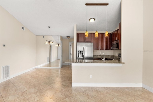 1208 Roma Ct, Orlando, FL 32825 - kitchen with dark stone counters, a sink, an inviting chandelier, appliances with stainless steel finishes, and visible vents