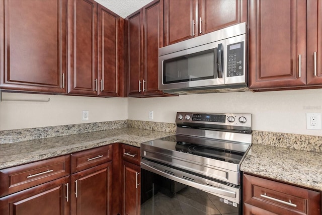 1208 Roma Ct, Orlando, FL 32825 - kitchen featuring light stone counters and stainless steel appliances
