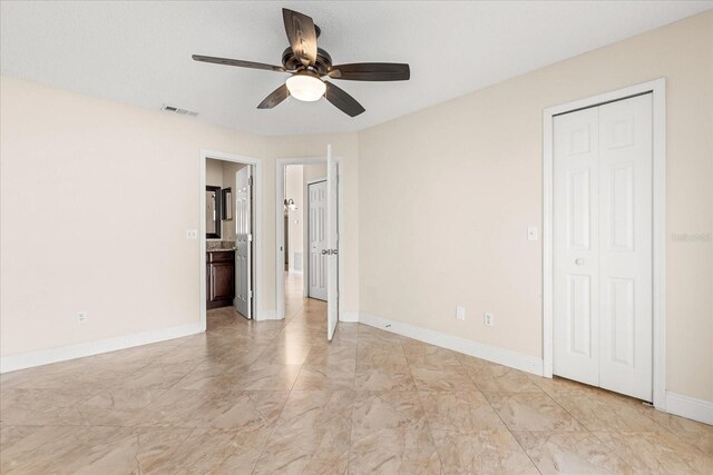 1208 Roma Ct, Orlando, FL 32825 - unfurnished bedroom with marble finish floor, visible vents, connected bathroom, baseboards, and ceiling fan
