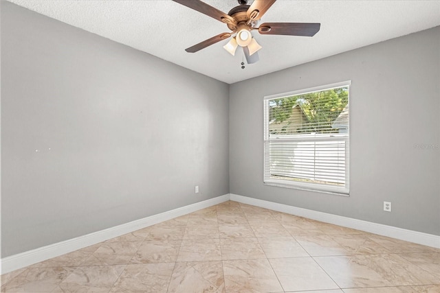 1208 Roma Ct, Orlando, FL 32825 - spare room featuring marble finish floor, baseboards, a ceiling fan, and a textured ceiling