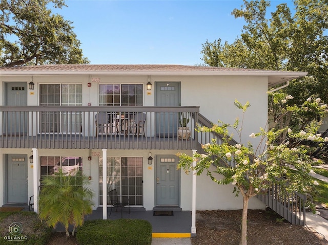4820 Conway Rd Unit 130, Orlando, FL 32812 - view of front of home featuring stucco siding and a balcony