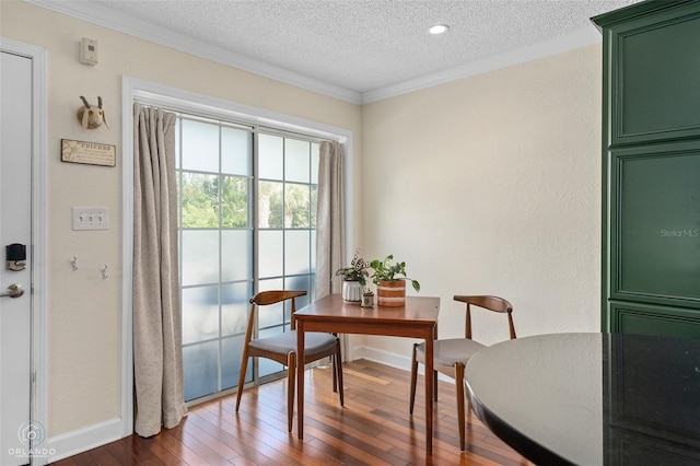 4820 Conway Rd Unit 130, Orlando, FL 32812 - dining space with dark wood-type flooring, a textured ceiling, ornamental molding, and baseboards