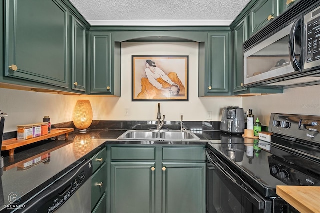 4820 Conway Rd Unit 130, Orlando, FL 32812 - kitchen with stainless steel appliances, green cabinets, a sink, a textured ceiling, and dark countertops