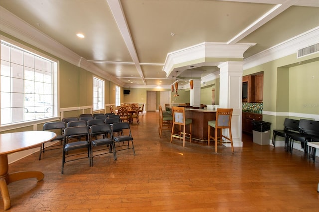 3344 Corona Village Way Unit 207, Orlando, FL 32835 - dining area with decorative columns, crown molding, hardwood / wood-style floors, and recessed lighting