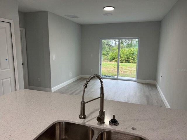 6935 Dickinson Dr, Sebring, FL 33872 - interior space with baseboards, wood finished floors, a sink, and visible vents