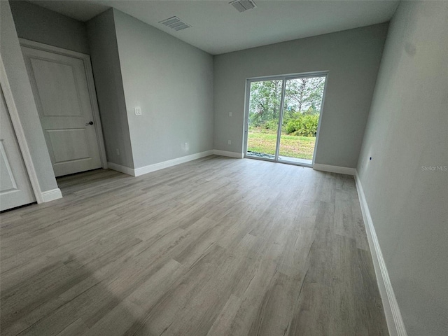 6935 Dickinson Dr, Sebring, FL 33872 - empty room featuring baseboards, light wood finished floors, and visible vents