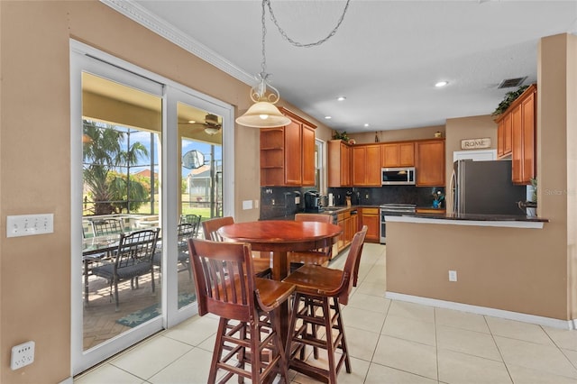2005 Pitch Way, Kissimmee, FL 34746 - dining room with recessed lighting, baseboards, light tile patterned floors, visible vents, and ornamental molding
