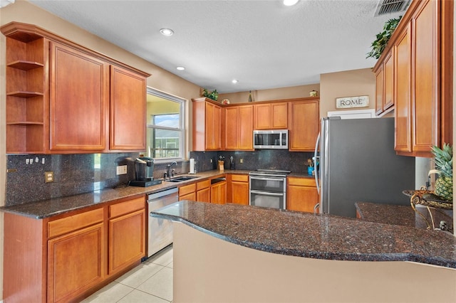 2005 Pitch Way, Kissimmee, FL 34746 - kitchen with open shelves, appliances with stainless steel finishes, a sink, a peninsula, and visible vents