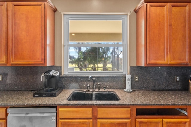 2005 Pitch Way, Kissimmee, FL 34746 - kitchen featuring stainless steel dishwasher, a sink, decorative backsplash, and dark stone counters
