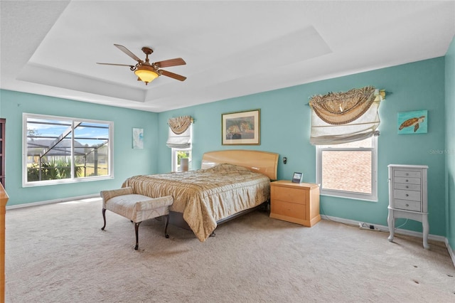 2005 Pitch Way, Kissimmee, FL 34746 - carpeted bedroom with baseboards, a tray ceiling, and ceiling fan