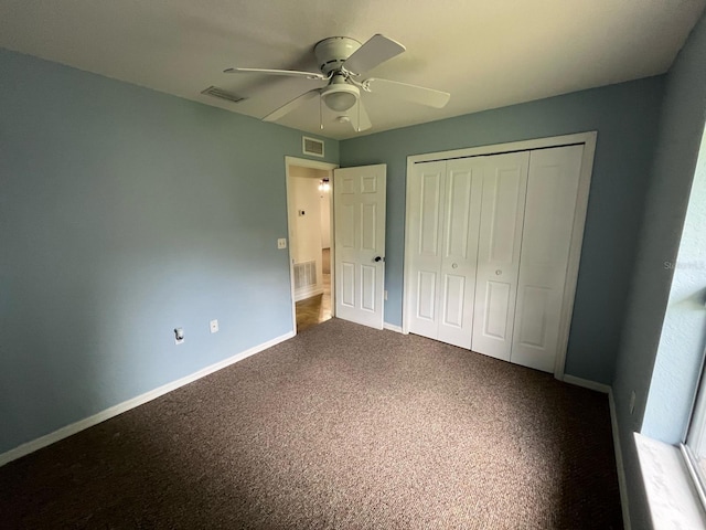 unfurnished bedroom with a closet, carpet, visible vents, and baseboards
