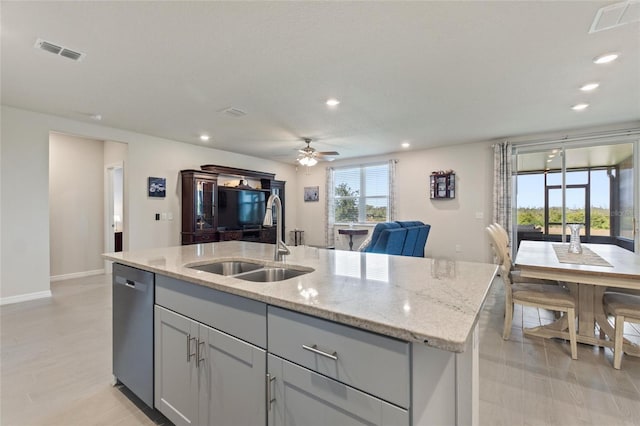 kitchen with a sink, a kitchen island with sink, visible vents, and stainless steel dishwasher