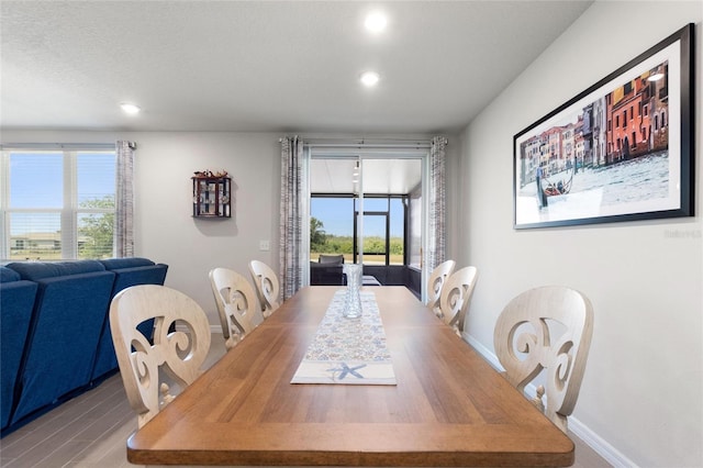 dining space with a wealth of natural light, light wood-style floors, recessed lighting, and baseboards