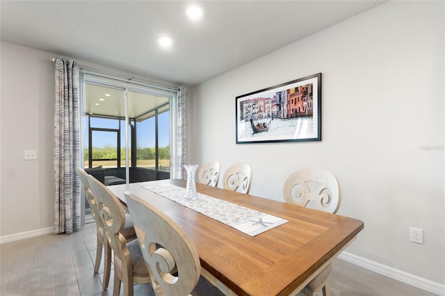 dining space with recessed lighting, light wood-style flooring, and baseboards