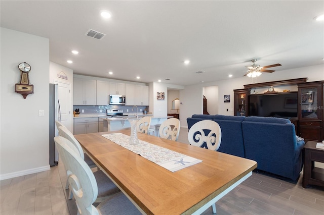dining space featuring wood finish floors, recessed lighting, and visible vents