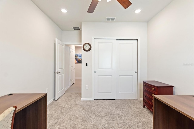 office area featuring baseboards, visible vents, light carpet, and ceiling fan