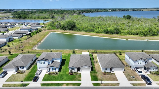 drone / aerial view featuring a residential view and a water view