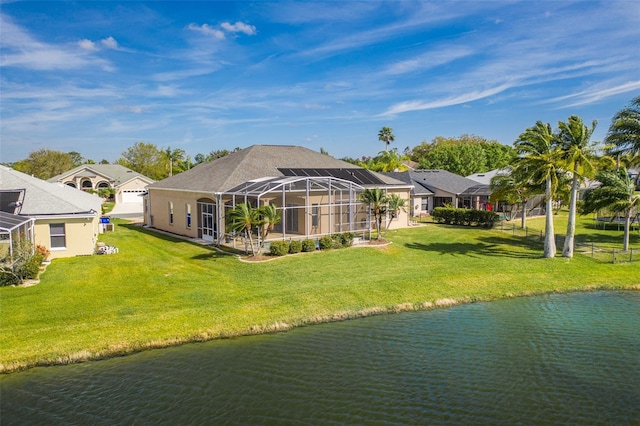 back of house featuring a lanai, a yard, and a water view