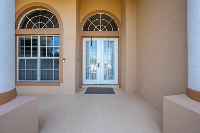 property entrance with french doors and stucco siding
