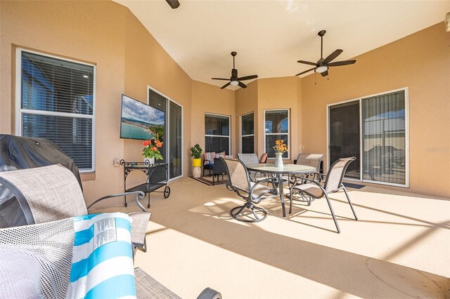 view of patio with a ceiling fan and outdoor dining space