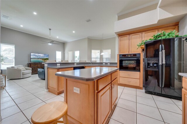 kitchen featuring light tile patterned flooring, crown molding, black appliances, a peninsula, and open floor plan