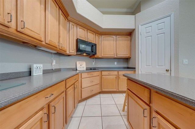kitchen with black appliances, ornamental molding, light brown cabinetry, and light tile patterned floors