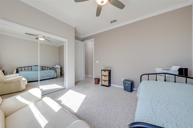 carpeted bedroom with ceiling fan, visible vents, baseboards, and ornamental molding