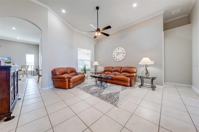 living area with a ceiling fan, crown molding, arched walkways, visible vents, and recessed lighting