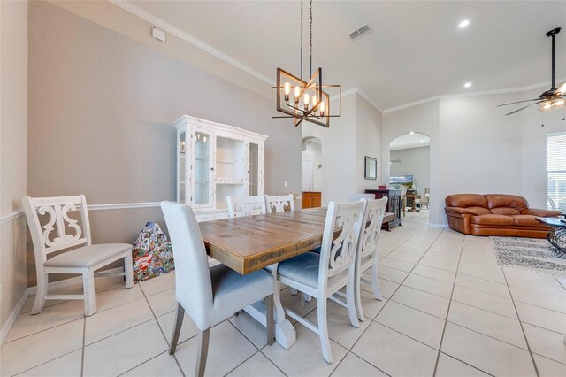 dining space featuring crown molding, ceiling fan with notable chandelier, light tile patterned floors, arched walkways, and visible vents