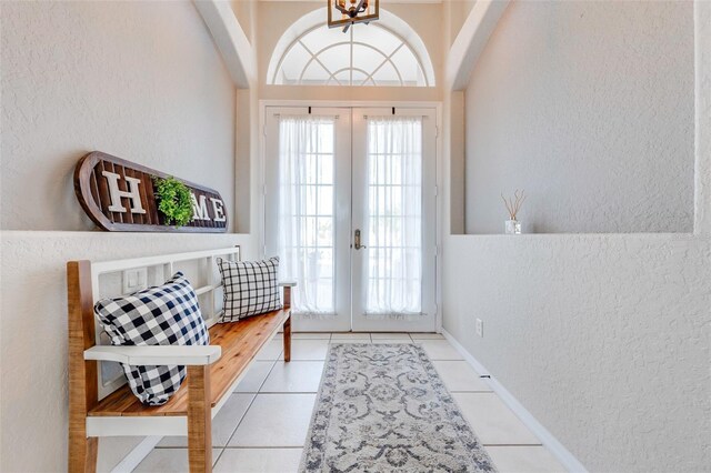 doorway to outside with a textured wall, french doors, and a healthy amount of sunlight