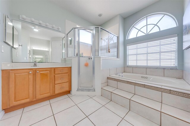 full bathroom featuring tile patterned floors, a garden tub, vanity, and a shower stall