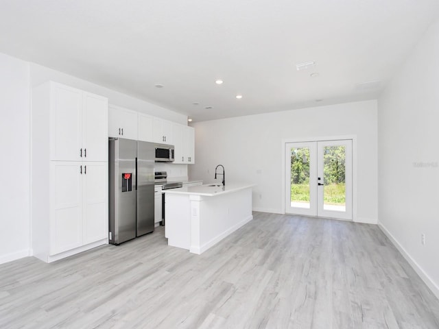 7744 Sun N Lake Blvd, Sebring, FL 33872 - kitchen featuring white cabinets, stainless steel appliances, light wood-type flooring, and a sink