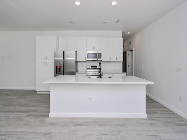 7744 Sun N Lake Blvd, Sebring, FL 33872 - kitchen featuring white cabinets, stainless steel appliances, a sink, and an island with sink