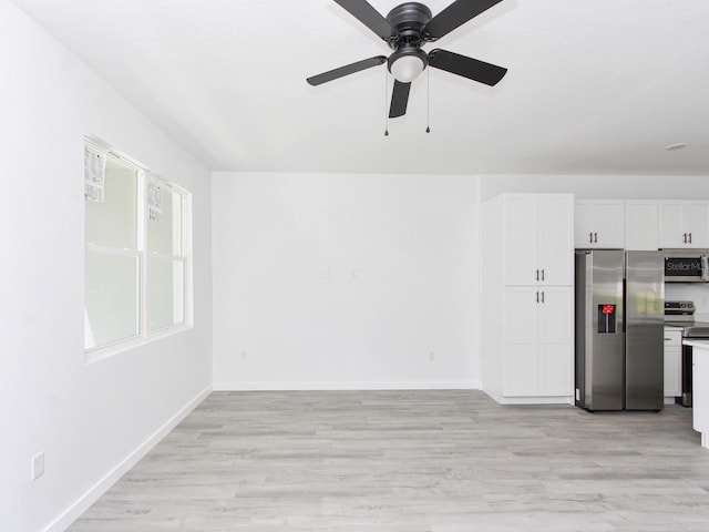 7744 Sun N Lake Blvd, Sebring, FL 33872 - unfurnished living room featuring light wood-style flooring, a ceiling fan, and baseboards