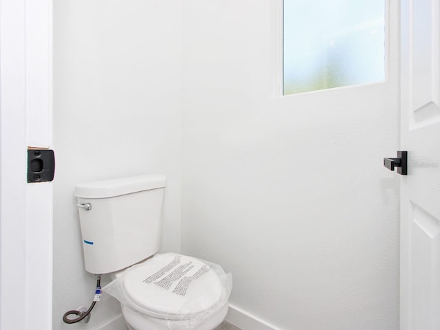 7744 Sun N Lake Blvd, Sebring, FL 33872 - bathroom featuring baseboards and toilet