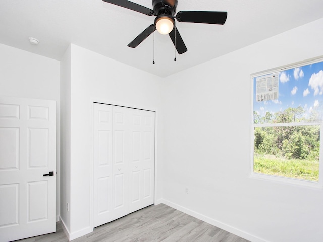 7744 Sun N Lake Blvd, Sebring, FL 33872 - unfurnished bedroom featuring ceiling fan, baseboards, light wood finished floors, and a closet