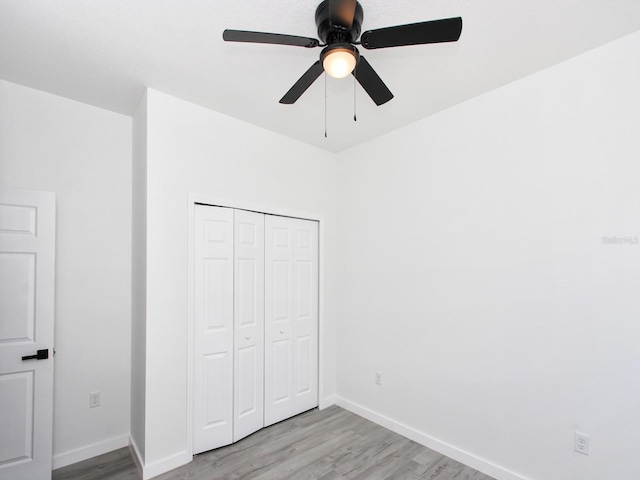 7744 Sun N Lake Blvd, Sebring, FL 33872 - unfurnished bedroom with a ceiling fan, baseboards, a closet, and light wood-type flooring