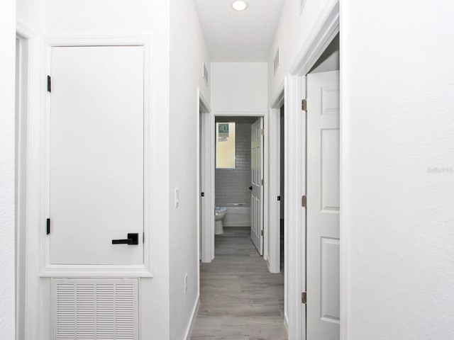 7744 Sun N Lake Blvd, Sebring, FL 33872 - hallway with light wood-style floors, visible vents, and recessed lighting