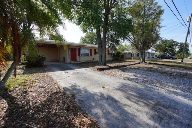 ranch-style house featuring driveway and an attached carport