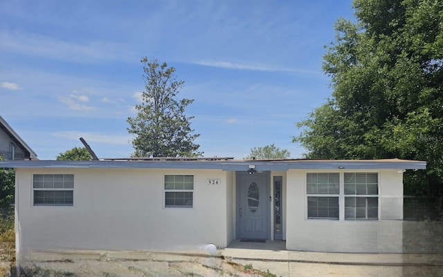 single story home featuring stucco siding