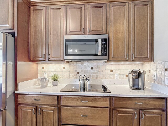 kitchen with backsplash and stainless steel appliances
