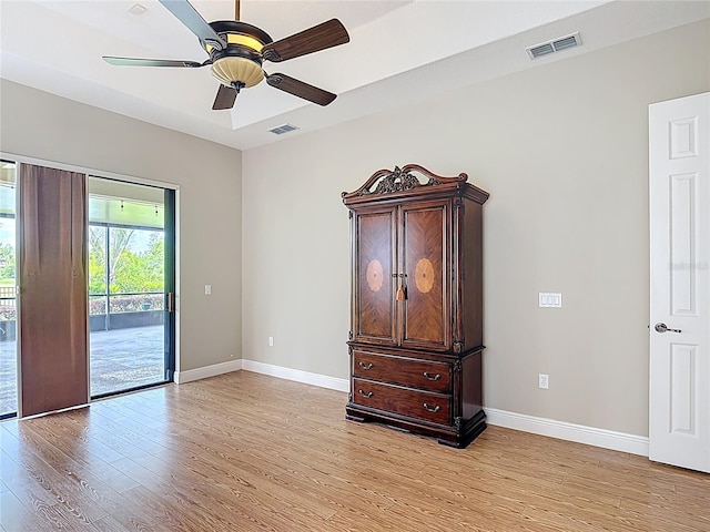 unfurnished room with visible vents, baseboards, ceiling fan, and light wood-type flooring