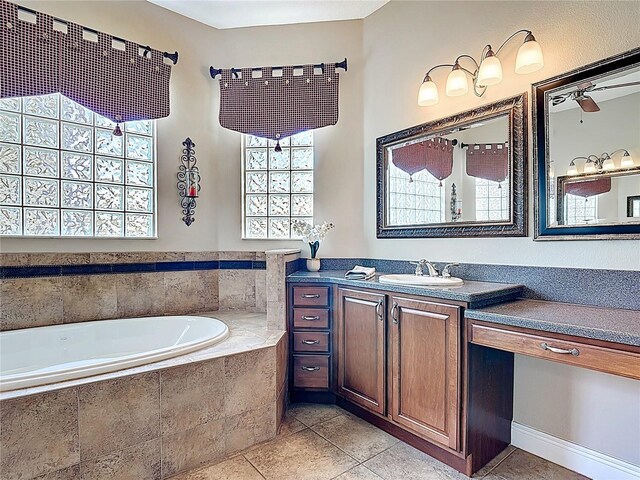 bathroom featuring vanity, tile patterned flooring, and a garden tub