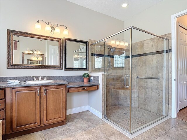full bath with recessed lighting, baseboards, a shower stall, and vanity