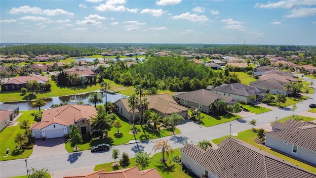 drone / aerial view with a residential view and a water view