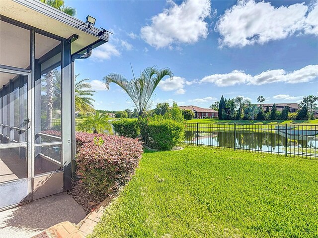 view of yard featuring fence and a water view