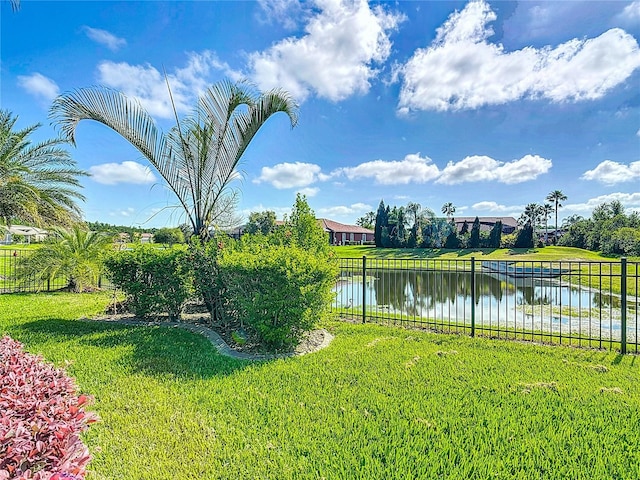 view of yard featuring fence and a water view