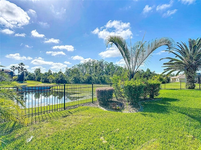 view of yard featuring fence and a water view
