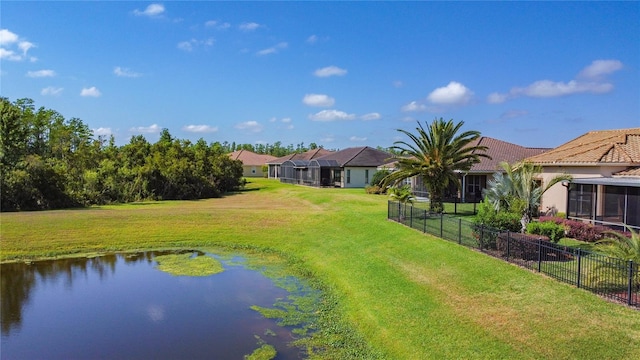 view of yard featuring fence and a water view